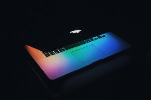 glowing macbook dark