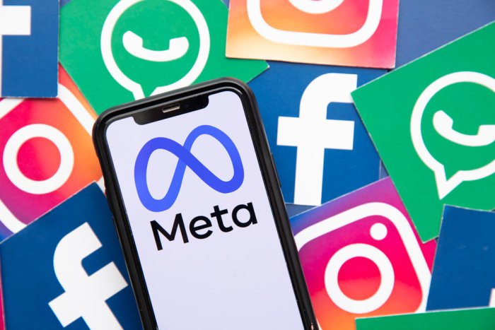 image showing the meta logo on a phone with whatsapp, facebook, and instagram logos in the background