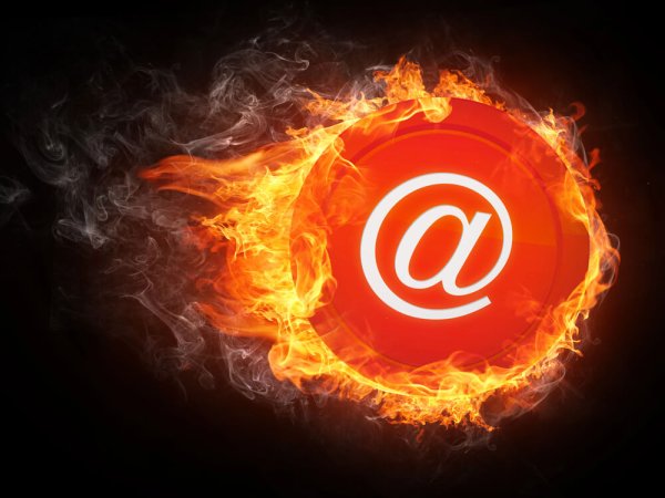 email "at" sign on fire on black background